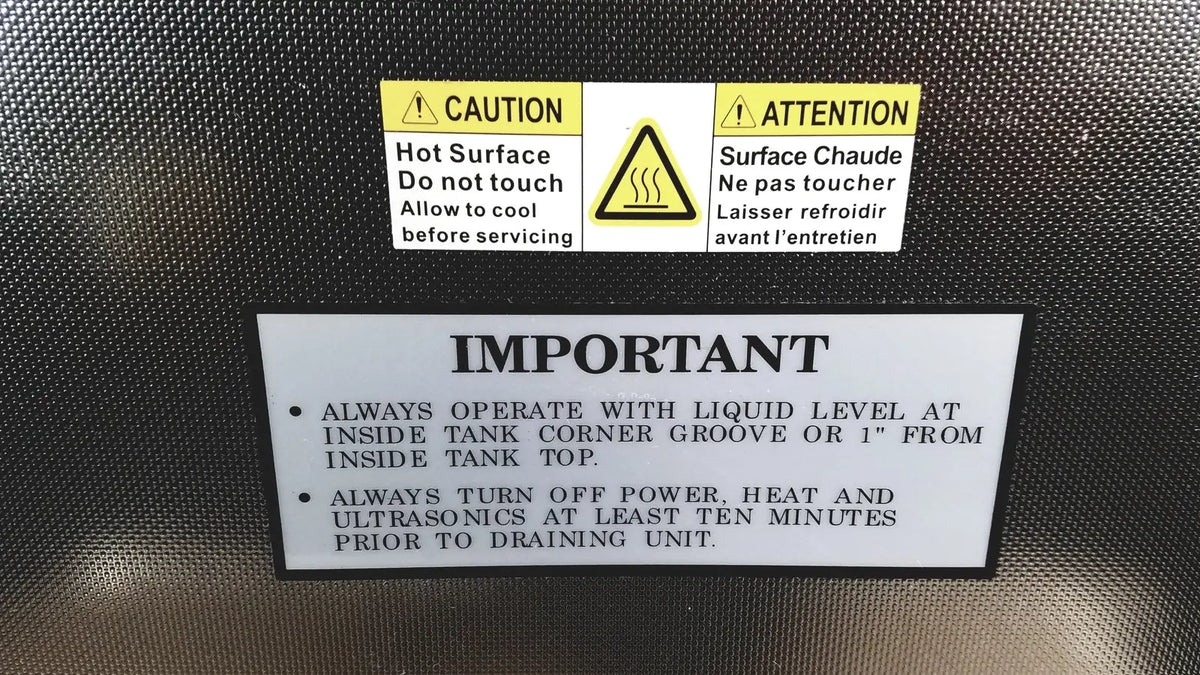 Black textured back surface of crest ultrasonic powersonic cleaner model p1100d with caution and warning labels in english and french