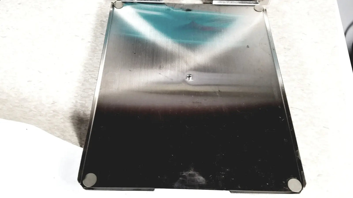 Stainless steel laptop base with black lower half and reflective upper surface of crest ultrasonic powersonic cleaner model p1100d