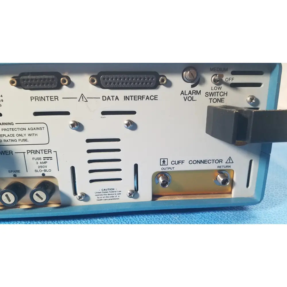 Blue plastic back panel of the Critikon Dinamap 1846 SX vital signs monitor with multiple ports and warning labels
