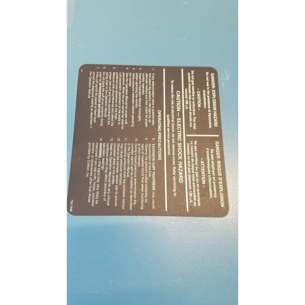 Brown rectangular warning label with black text on the back of critikon dinamap 1846 sx vital signs monitor with oxytrak pulse oximeter