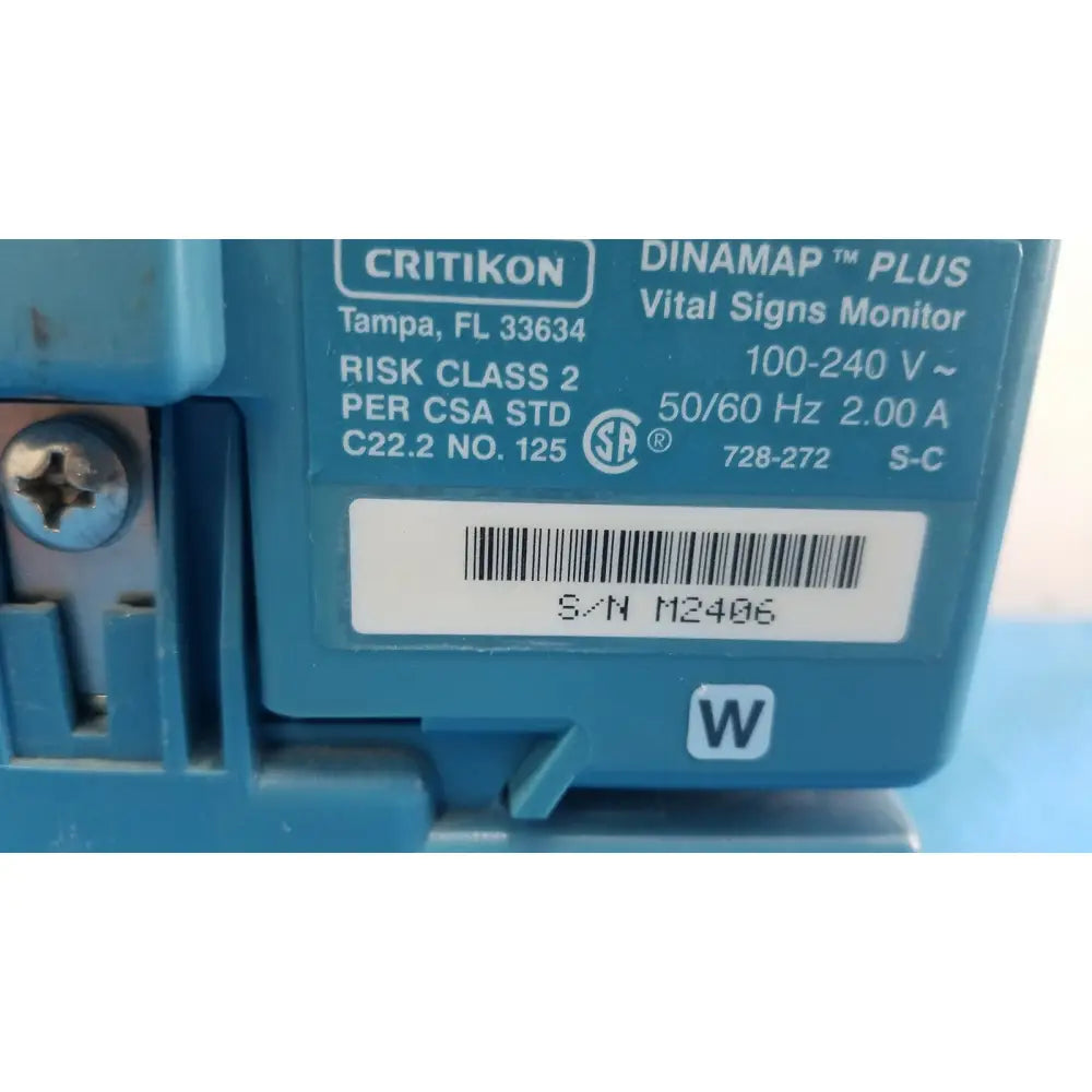 Blue plastic critikon dinamap plus vital signs monitor with white label showing serial number and specifications