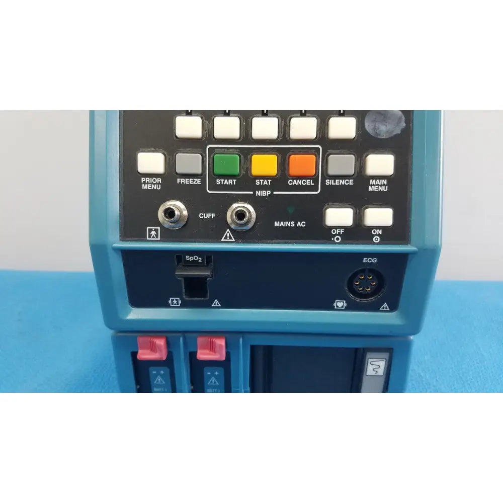 Blue critikon dinamap plus vital signs monitor 8726 rad with black control panel showing labeled buttons and ports back view