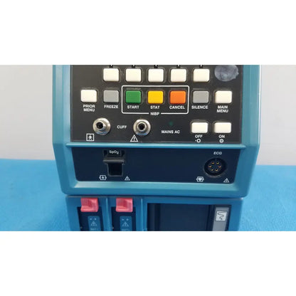 Blue critikon dinamap plus vital signs monitor 8726 rad with black control panel showing labeled buttons and ports back view