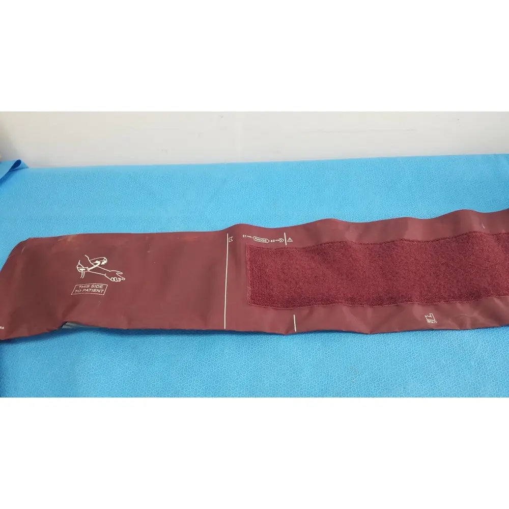 Critikon dura-cuf large adult blood pressure cuff maroon with textured fabric and white printed markings for adult blood pressure