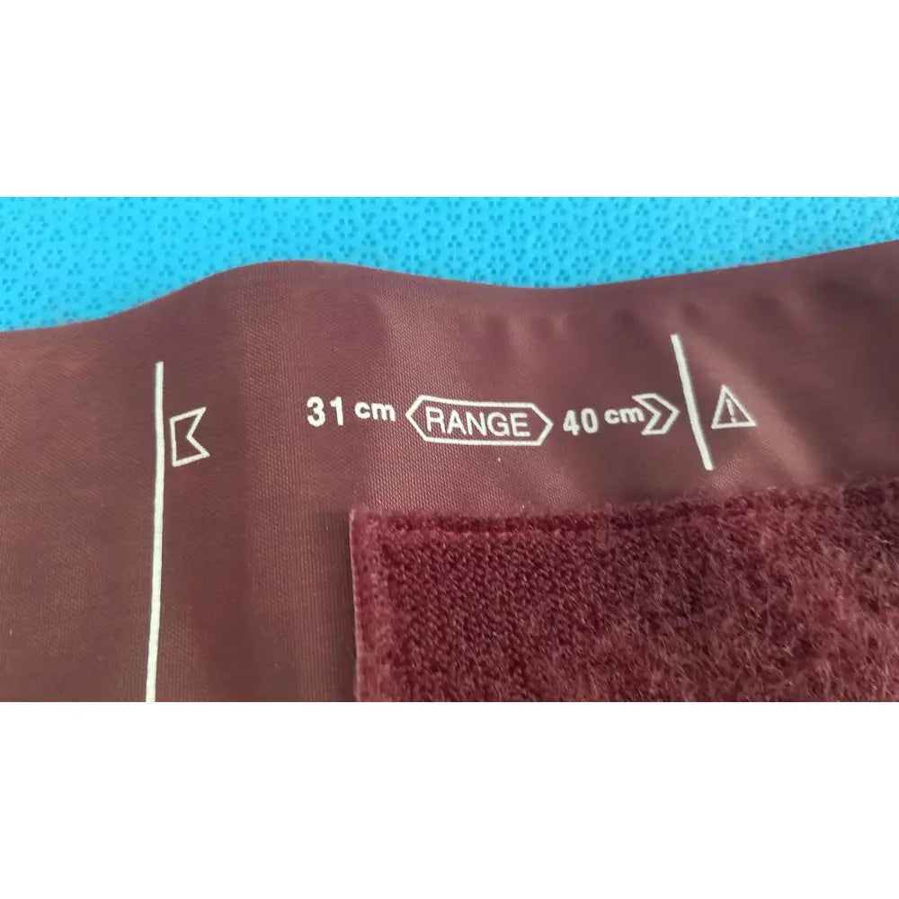 Critikon DURA-CUF large adult blood pressure cuff 2207 in maroon fabric with white measurement markings for blood pressure