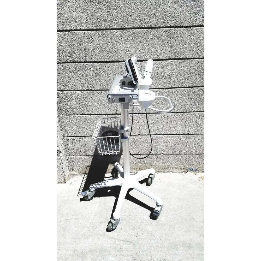 White medical cart with mounted diagnostic device and wire basket for cubescan biocon-700 bladder volume measurement system