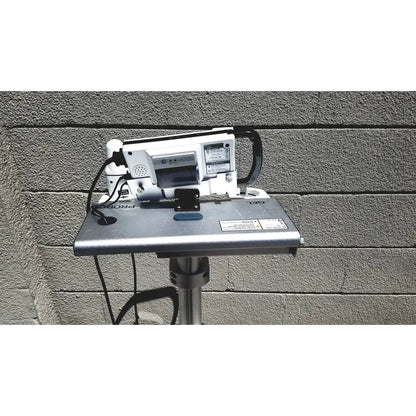Silver metallic projector stand with white and black projector in cubescan biocon-700 bladder volume measurement system