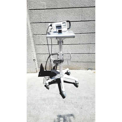 White medical cart with wheeled base and metal basket holding cubescan biocon-700 for bladder volume measurement