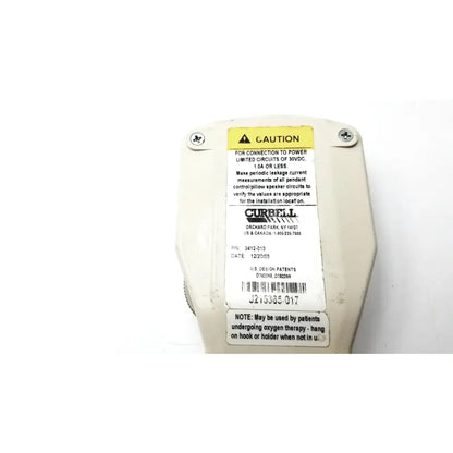 Off-white plastic curbell gen iii analog patient pillow speaker enclosure with yellow caution label and installation instructions