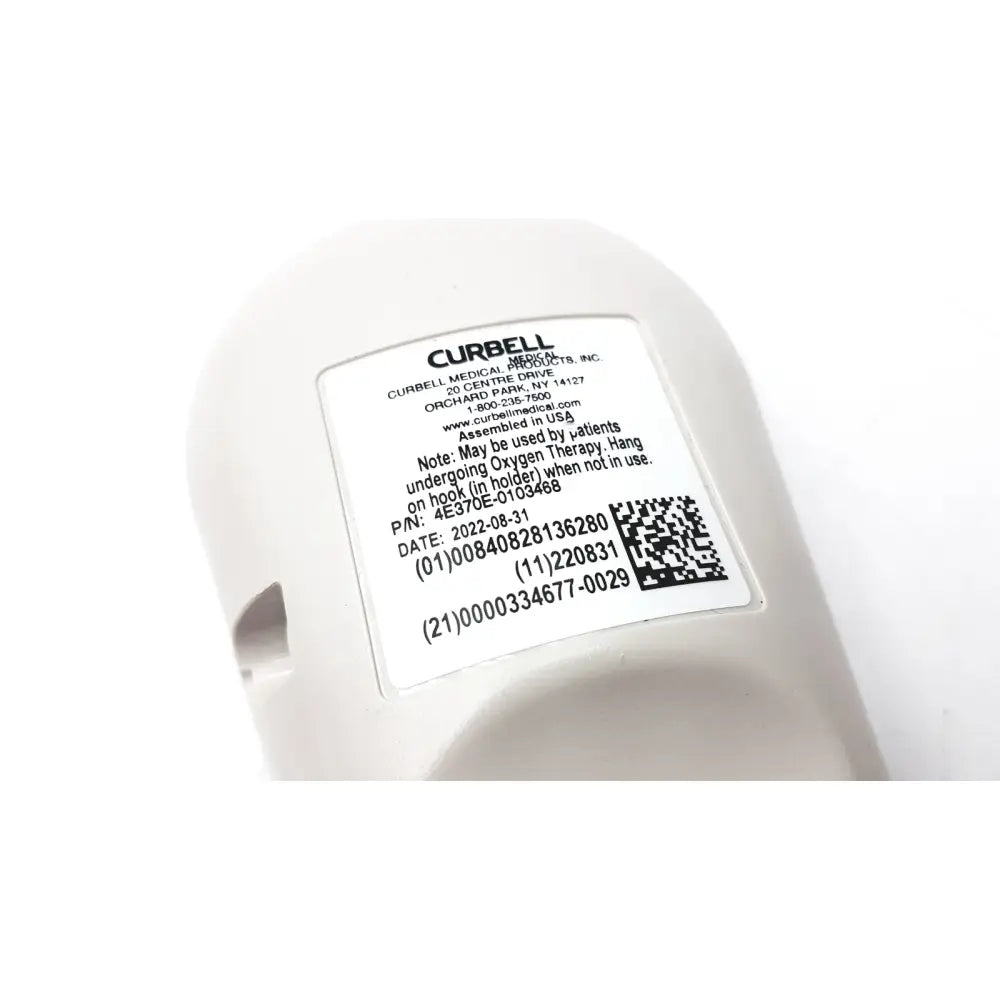 White plastic medical oxygen delivery device with manufacturer label on curbell getwell network nurse call remote