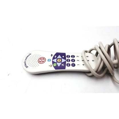 White plastic curbell getwell network nurse call remote with purple and blue buttons and circular speaker grille on left side