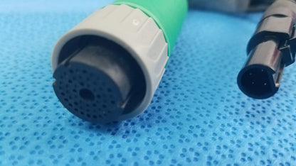 Green and gray medical-grade catheter connector cable with perforated black tip for reuse medical equipment applications
