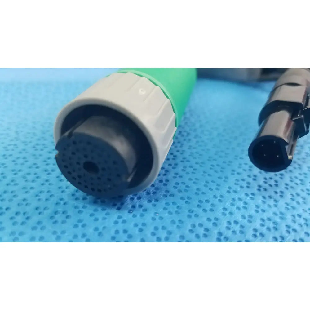 Green and gray medical-grade catheter connector cable with perforated black tip for reuse medical equipment applications
