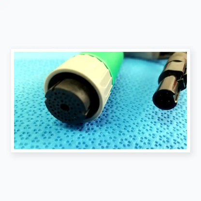 Green and gray medical-grade catheter connector cable with perforated black tip for reuse medical equipment applications