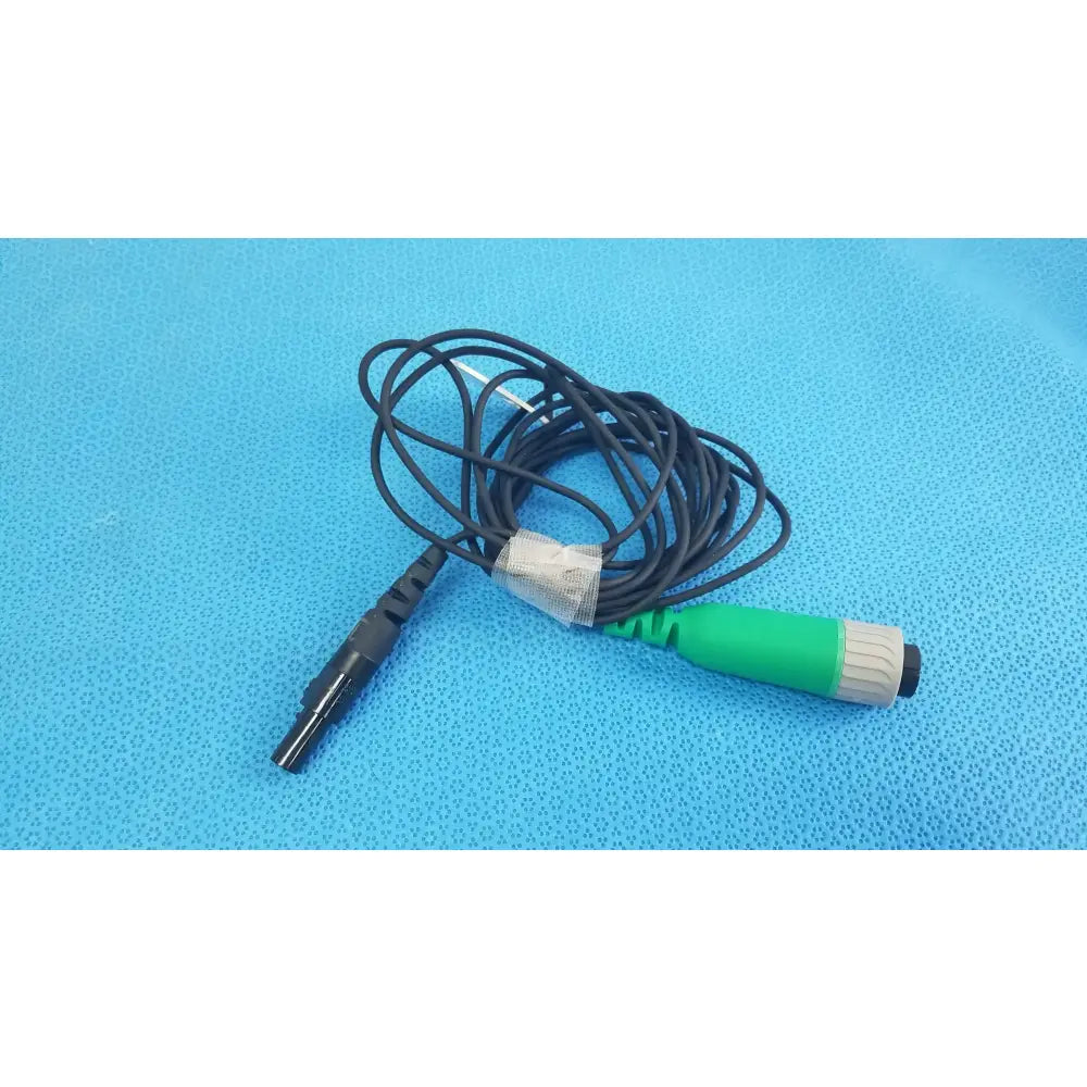 Green and gray medical catheter connector cable with black coiled wire for reuse medical equipment in EnSite X system