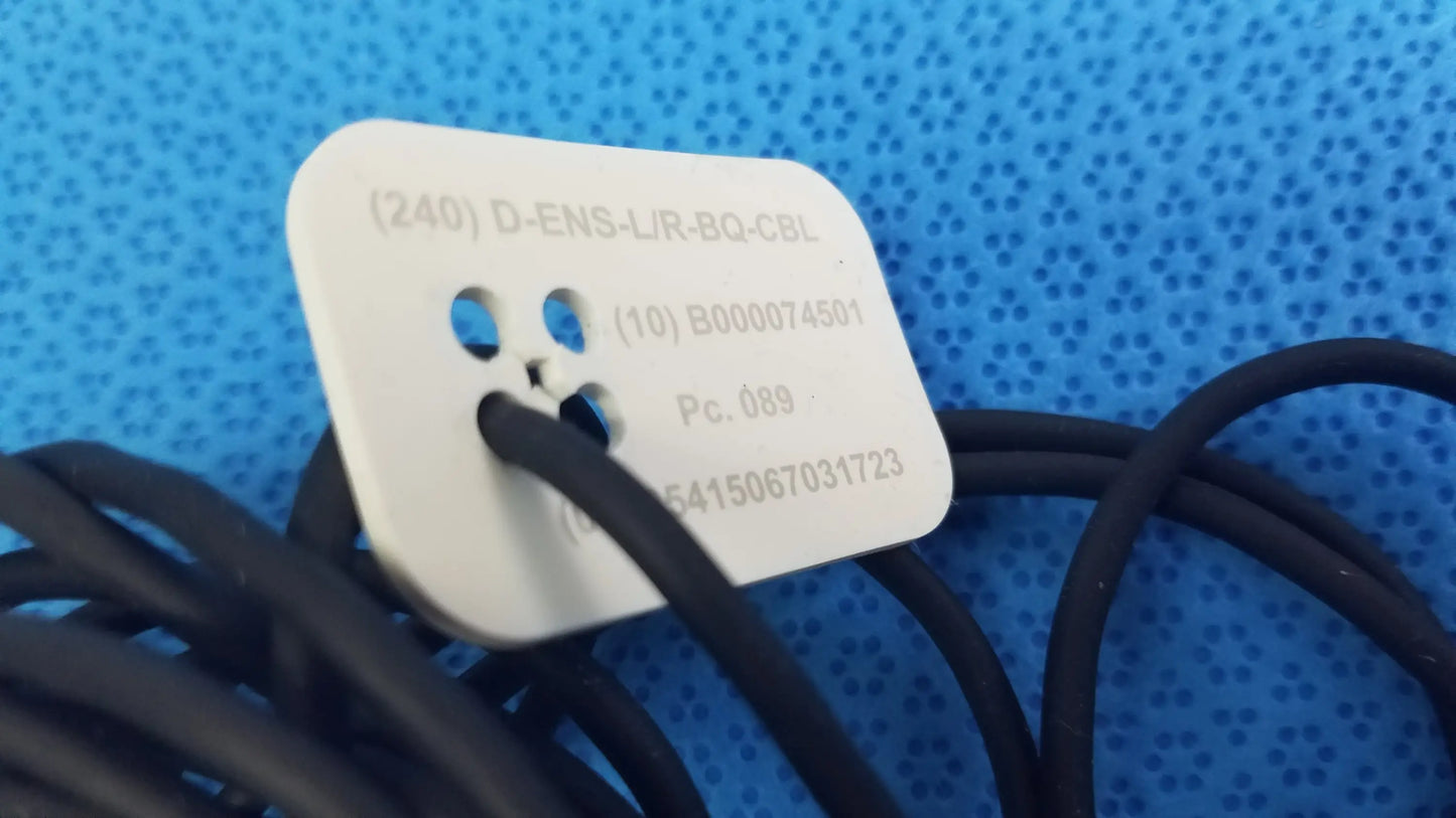 White rectangular label with rounded corners and alphanumeric codes on catheter connector cable for medical equipment reuse