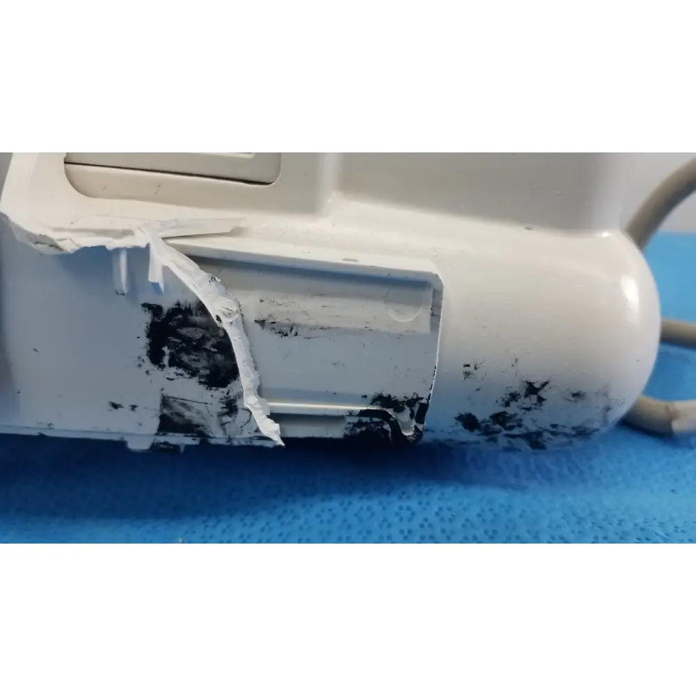 White plastic dash 3000 masimo set ref patient monitor with chipped paint and black residue on its surface