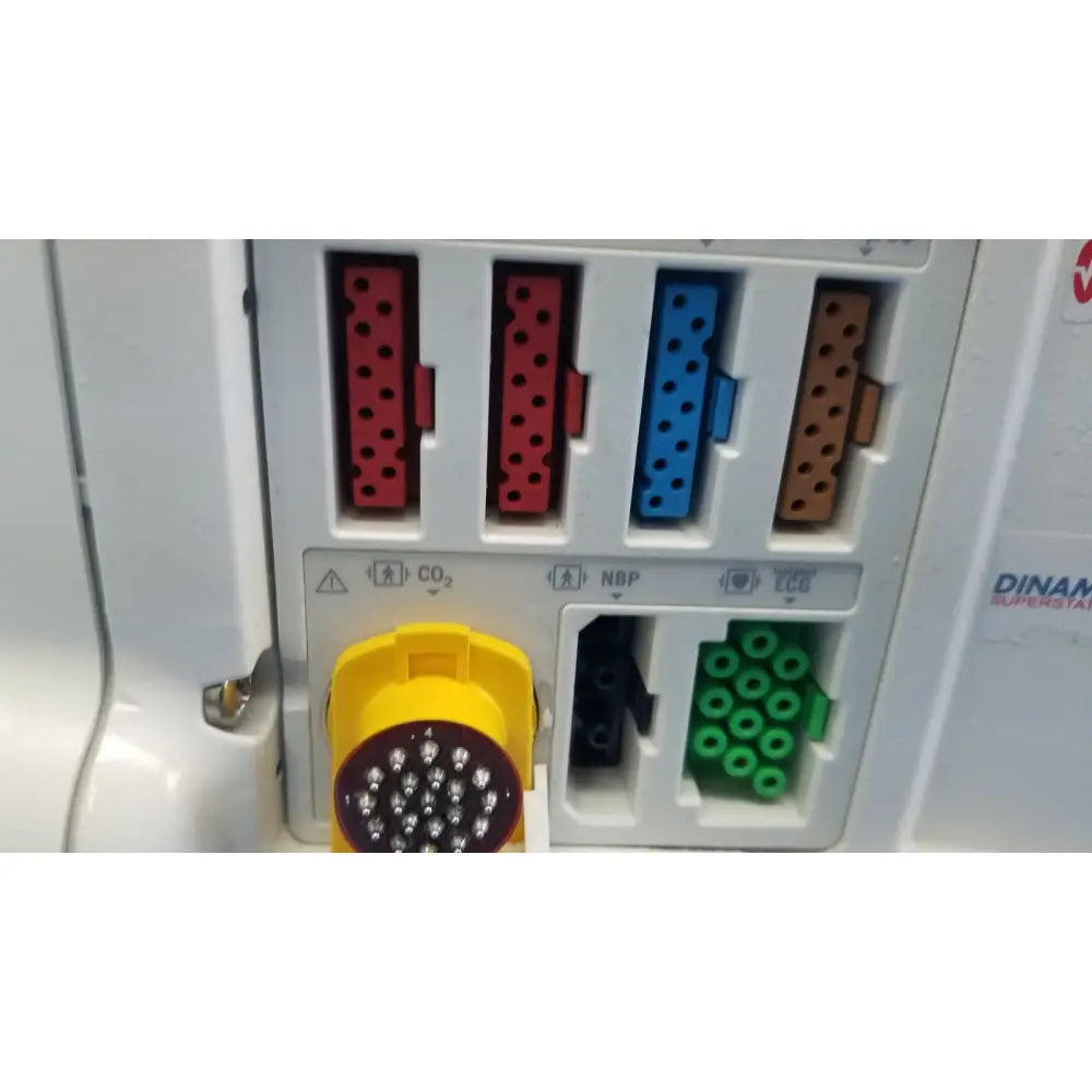 Yellow circular masimo set ref connector with white dots on white plastic panel of dash 3000 patient monitor back side