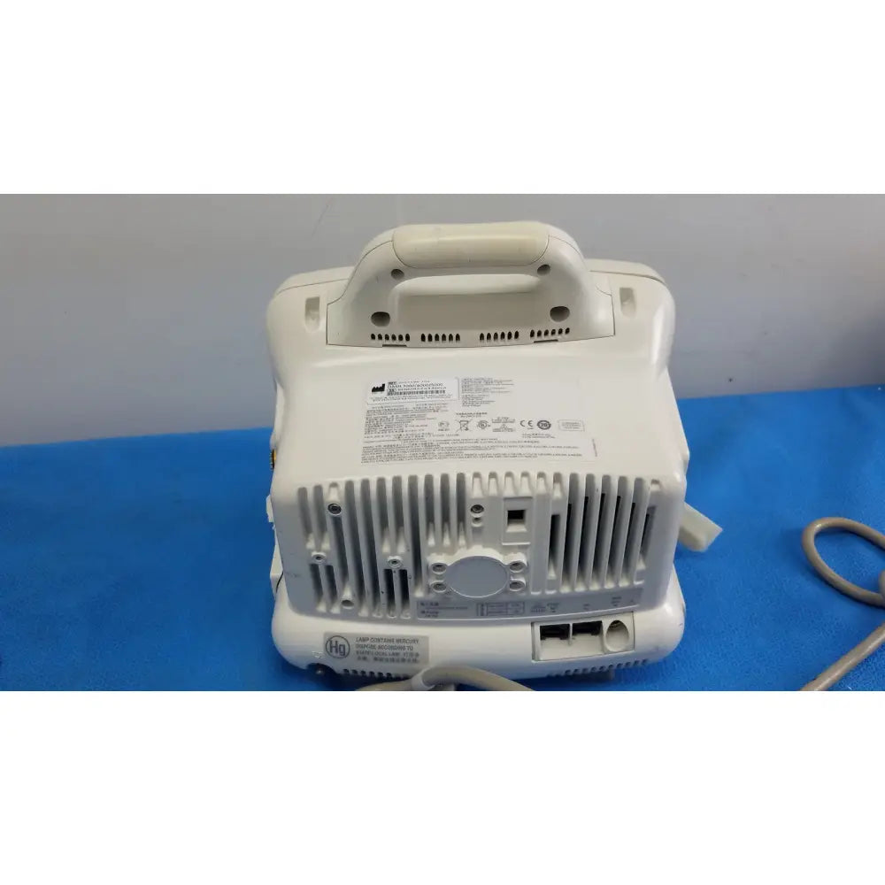 White plastic portable medical device with handle and ventilation slats in masimo set ref patient monitor dash 3000