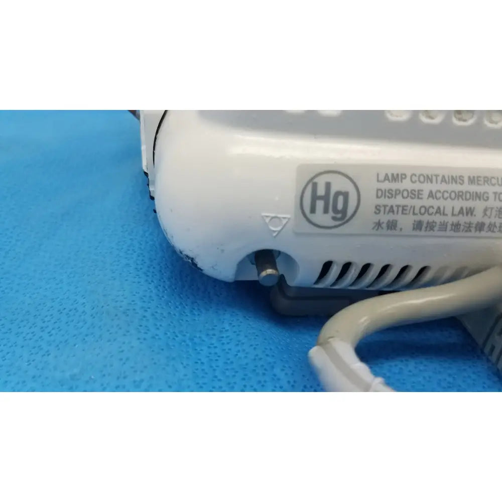 White plastic lamp base with mercury warning label on the back of dash 3000 masimo set ref patient monitor
