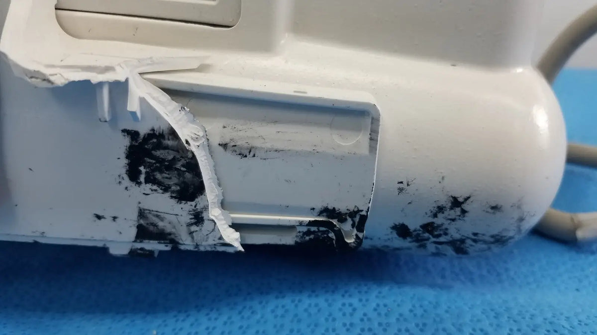 White plastic dash 3000 masimo set ref patient monitor with chipped paint and black residue on its surface
