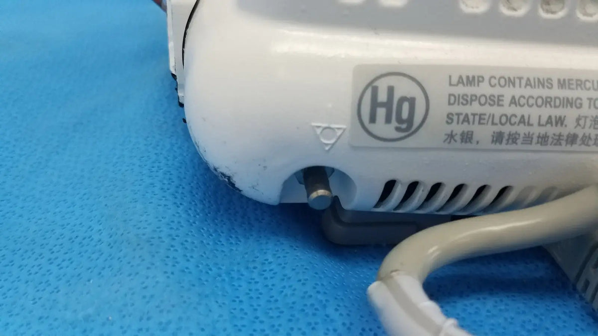 White plastic lamp base with mercury warning label on the back of dash 3000 masimo set ref patient monitor