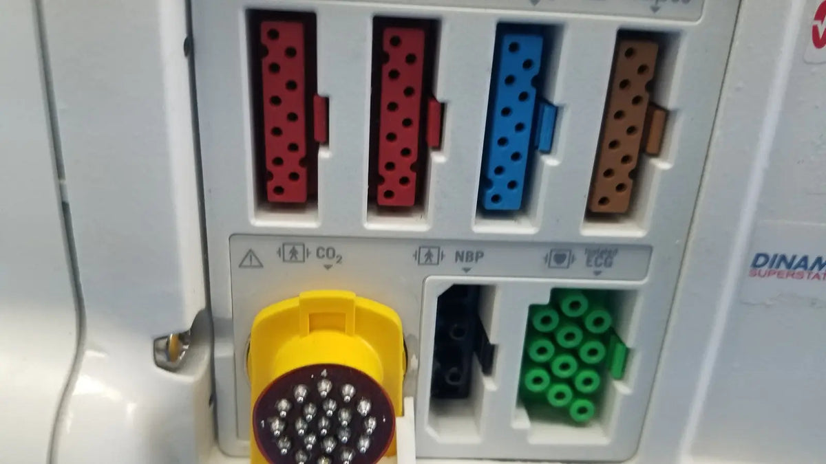 Yellow circular masimo set ref connector with white dots on white plastic panel of dash 3000 patient monitor back side