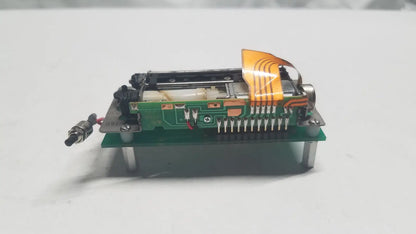 Green data synceng circuit board with orange flexible ribbon cable and metallic components featuring PIC16F628A chip