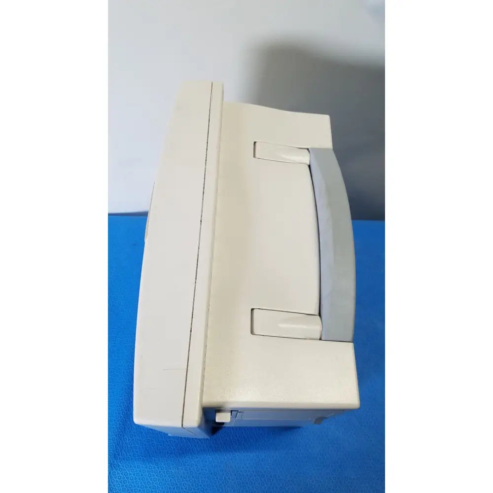 Beige plastic datascope passport 2 ecg nibp ekg patient monitor with gray handle and latch for nibp ekg monitoring
