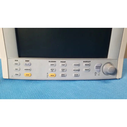 White datascope passport 2 ecg nibp ekg patient monitor with black screen and gray control panel featuring labeled buttons