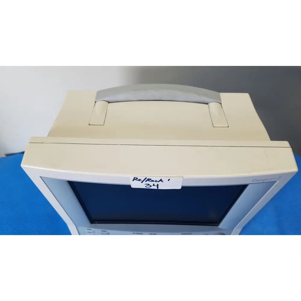 Beige plastic datascope passport 2 ecg nibp ekg patient monitor with gray handle and pansophic branding