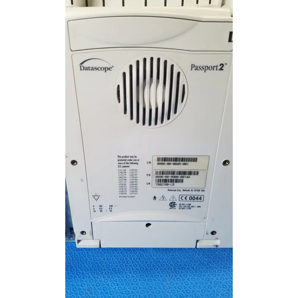 White datascope passport 2 ecg nibp ekg patient monitor control panel with circular vent grille and printed specifications