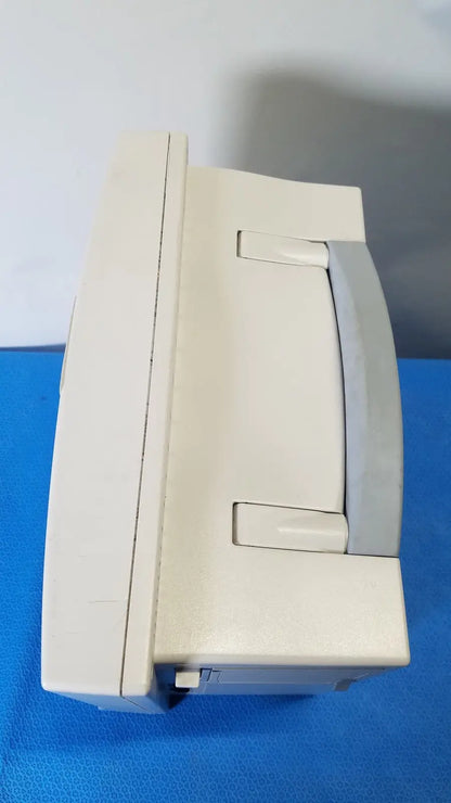 Beige plastic datascope passport 2 ecg nibp ekg patient monitor with gray handle and latch for nibp ekg monitoring