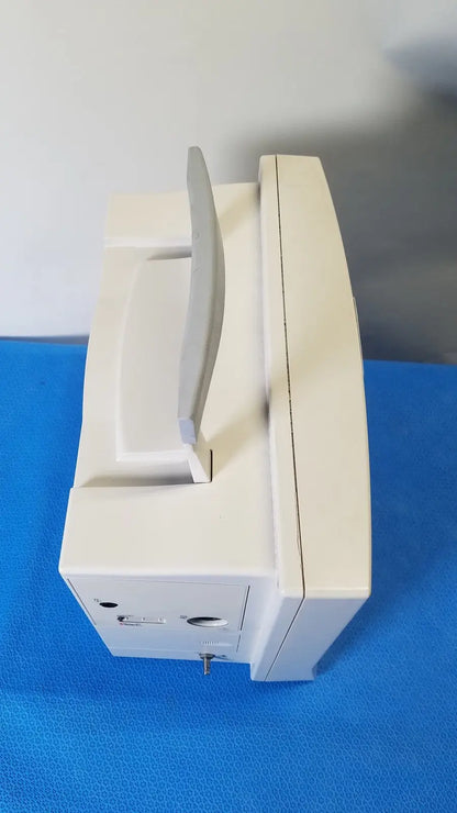 Cream-colored plastic datascope passport 2 ecg nibp ekg patient monitor with curved screen and integrated handle