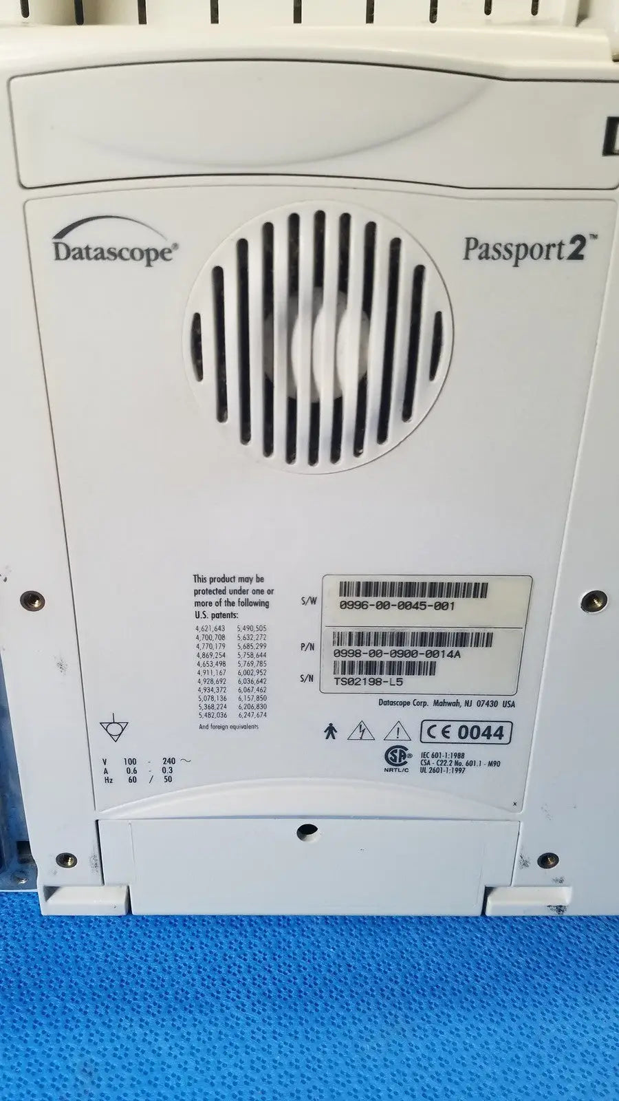 White datascope passport 2 ecg nibp ekg patient monitor control panel with circular vent grille and printed specifications