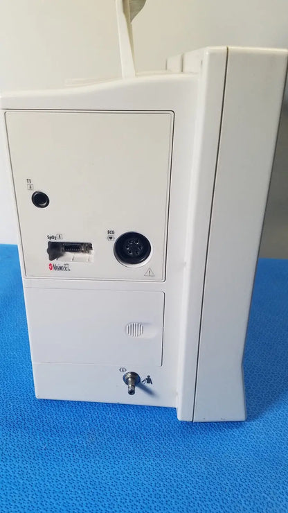 White plastic datascope passport 2 ecg nibp ekg patient monitor with labeled ports and keyhole on the back side