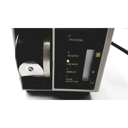 Black and silver datex ohmeda tec 6 desflurane anesthesia vaporizer with illuminated status indicators for precise anesthesia delivery