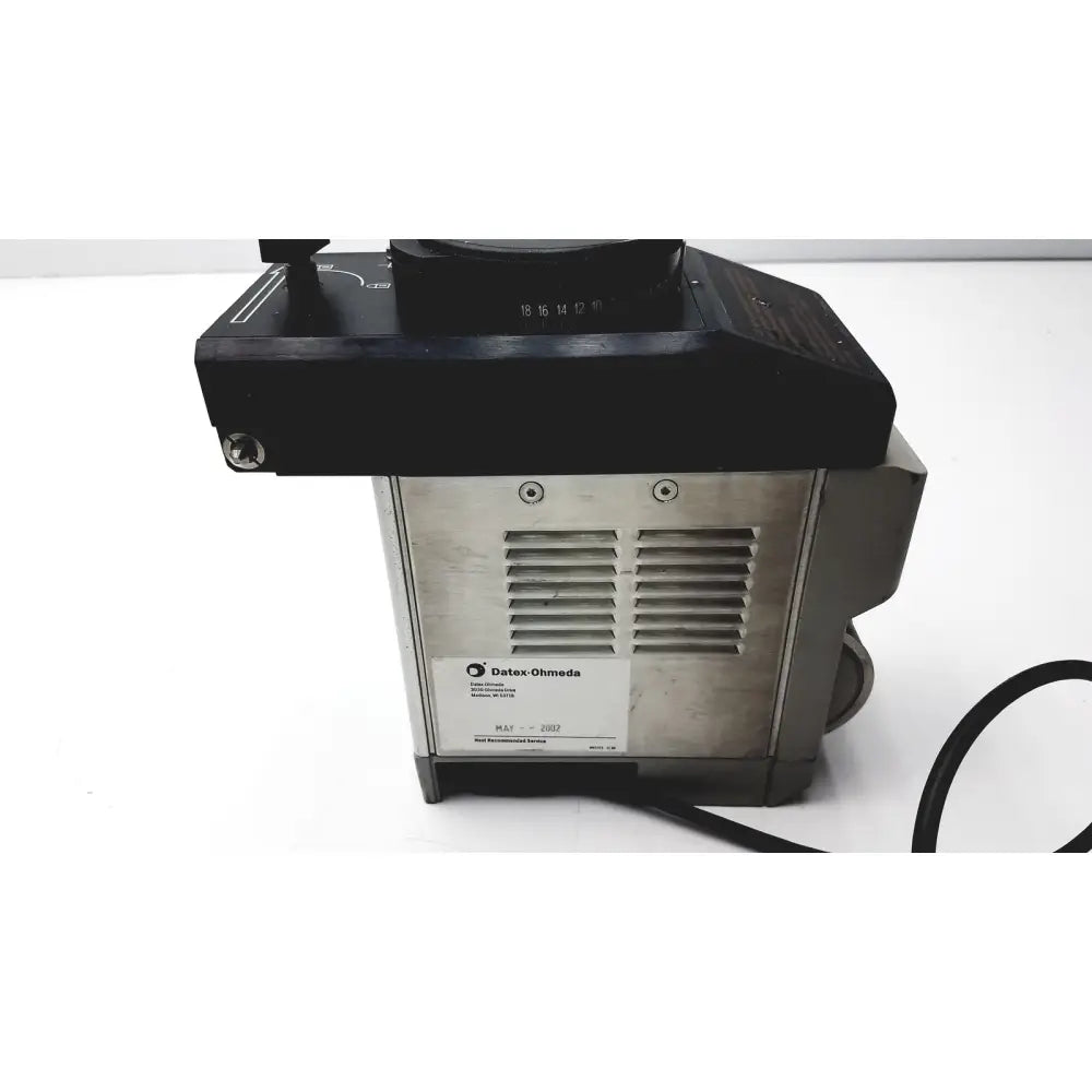 Black and silver Datex Ohmeda TEC 6 desflurane anesthesia vaporizer with numbered black top section for precise control