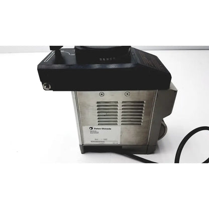Black and silver Datex Ohmeda TEC 6 desflurane anesthesia vaporizer with numbered black top section for precise control