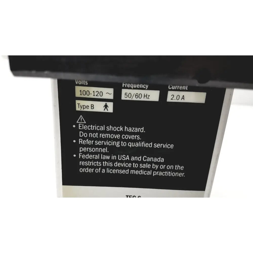 Black electrical specification label on the back of datex ohmeda tec 6 desflurane anesthesia vaporizer with voltage and safety details