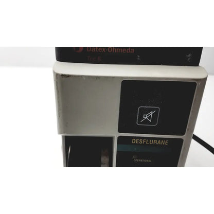 Datex ohmeda tec 8 anesthesia machine with gray casing and black control panel featuring desflurane anesthesia vaporizer indicator