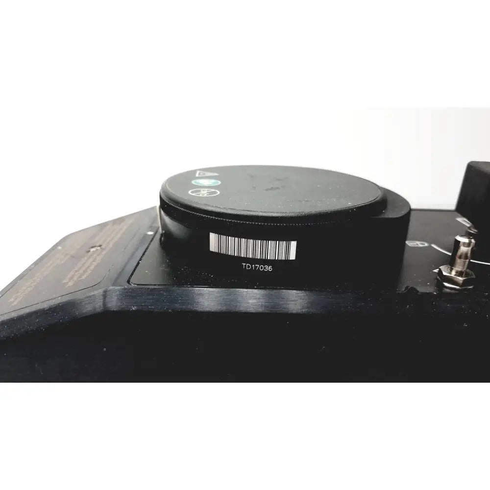 Black circular component with barcode and model number td17036 on the datex ohmeda tec 6 desflurane anesthesia vaporizer