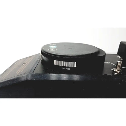 Black circular component with barcode and model number td17036 on the datex ohmeda tec 6 desflurane anesthesia vaporizer