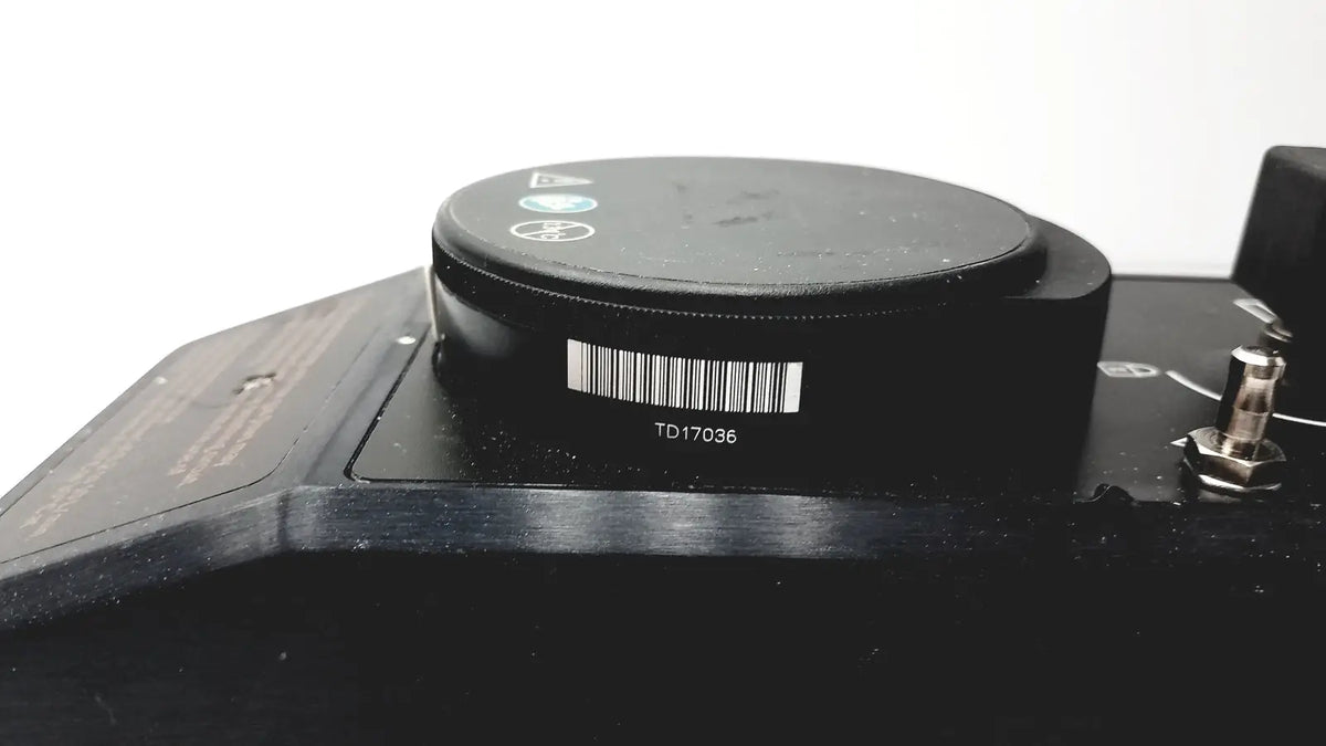 Black circular component with barcode and model number td17036 on the datex ohmeda tec 6 desflurane anesthesia vaporizer