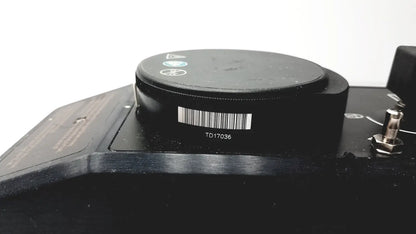 Black circular component with barcode and model number td17036 on the datex ohmeda tec 6 desflurane anesthesia vaporizer