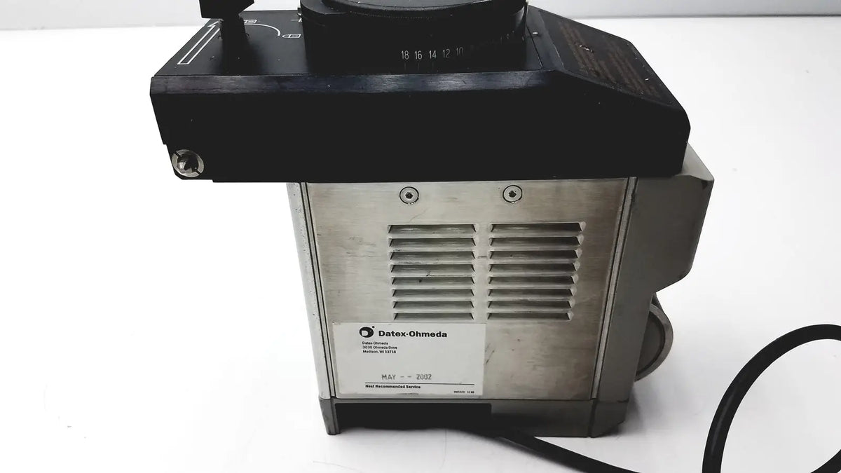 Black and silver Datex Ohmeda TEC 6 desflurane anesthesia vaporizer with numbered black top section for precise control