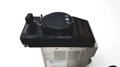 Black control panel with circular dial and toggle switch on silver base of datex ohmeda tec 6 desflurane anesthesia vaporizer