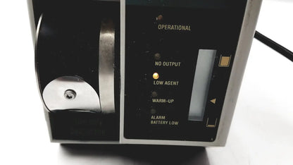 Black and silver datex ohmeda tec 6 desflurane anesthesia vaporizer with illuminated status indicators for precise anesthesia delivery