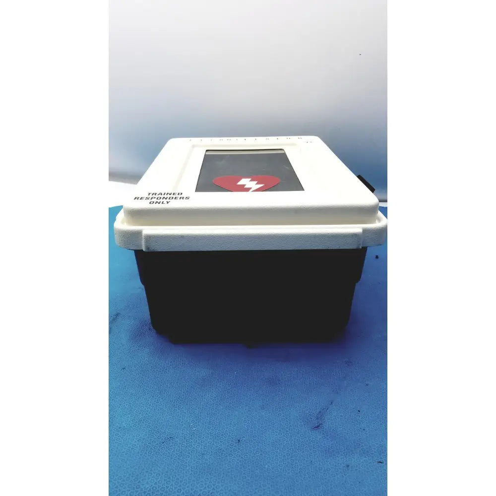 Defibrillator storage cabinet wall mount in white and black with a red heart symbol on the screen for emergency use