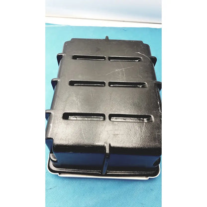 Black plastic defibrillator storage cabinet wall mount with three horizontal slots on each side for secure storage